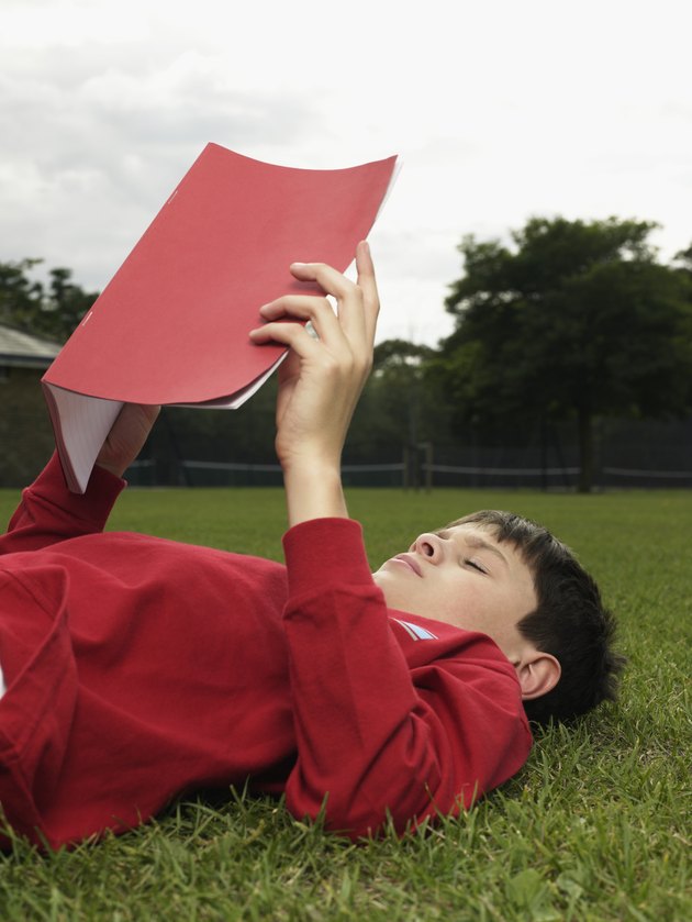 Boy with a notebook in park