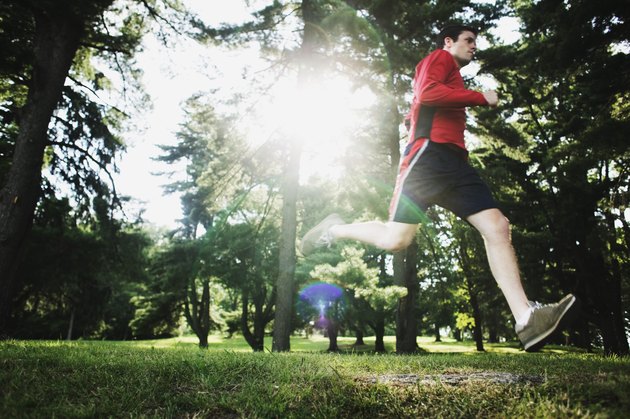 Man running through forest