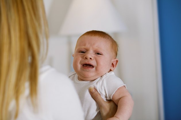 Mother holding crying baby