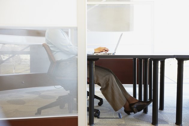 Businesswoman sitting at desk with laptop