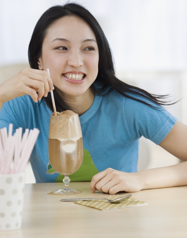 Asian woman drinking milkshake