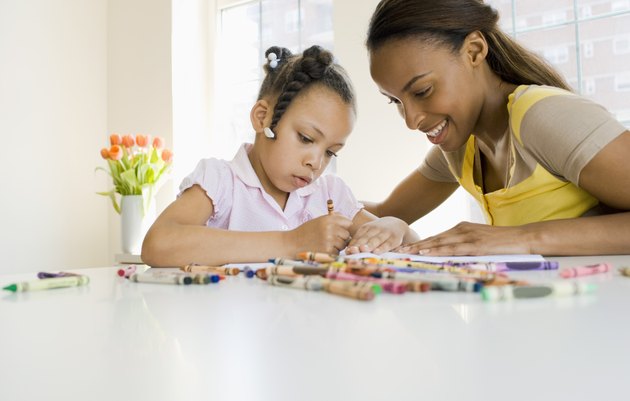 Mother and daughter coloring with crayons