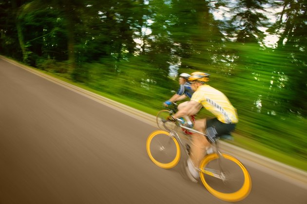 Two people racing on bikes