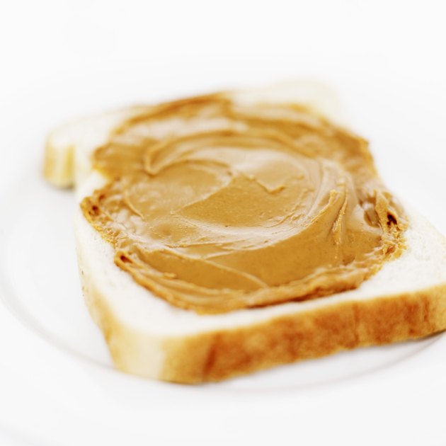 close-up of peanut butter spread on a slice of white bread