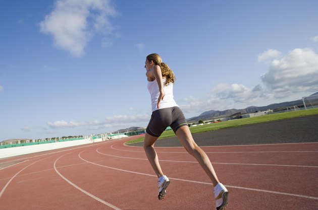 Woman running on track