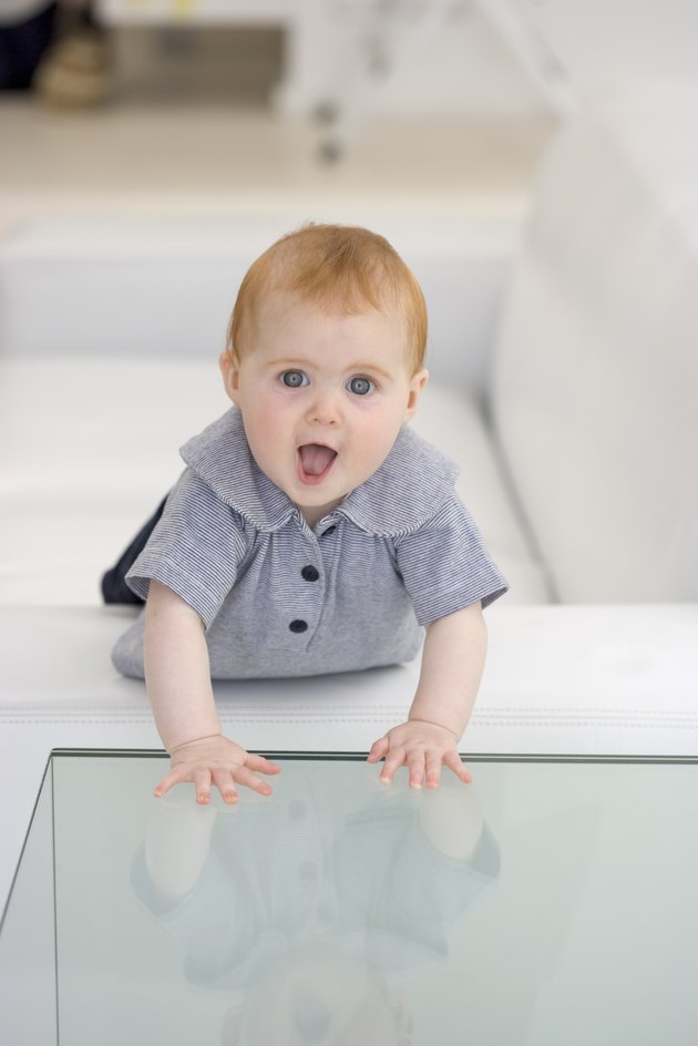 Baby with hands on glass