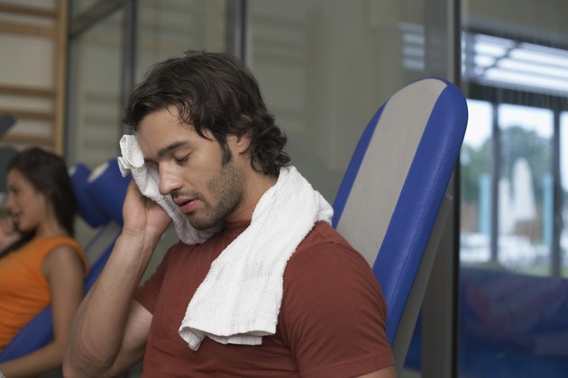 Man wiping his brow after exercising