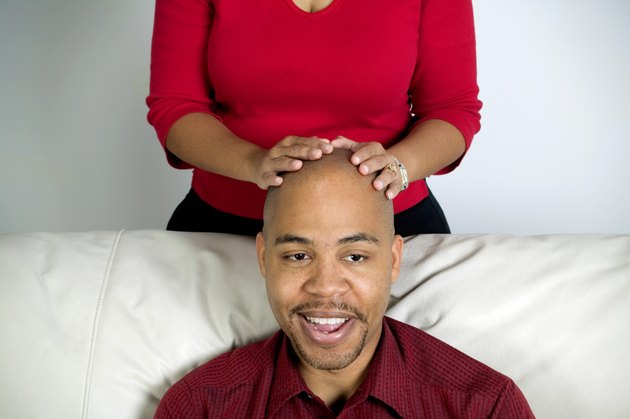 Man with a woman's hands on his head