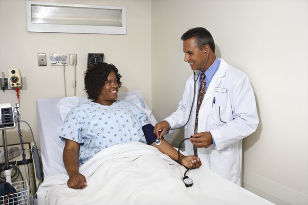 Doctor taking patient's blood pressure