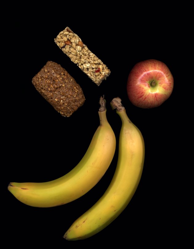 Fruit and healthy snacks on black background
