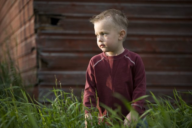 A young boy in tall grass