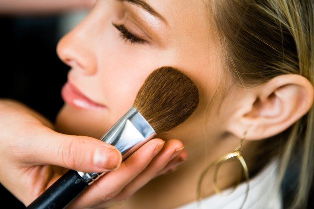 Woman having make-up applied