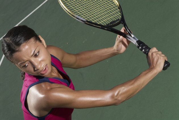 Woman holding tennis racket on court