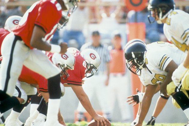 Football players at scrimmage line during game