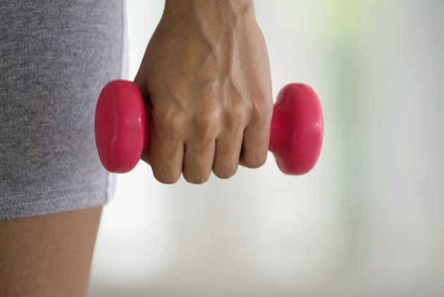 Young woman exercising with weights