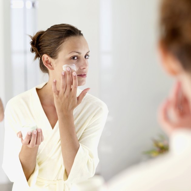 woman applying face cream