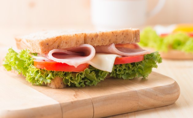 sandwich on wood plate.