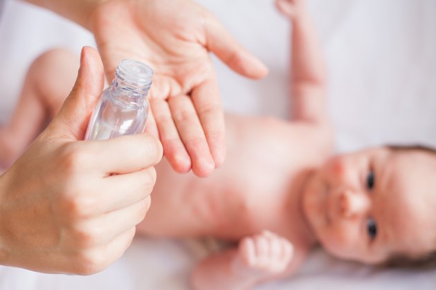 Mother makes massage for happy baby