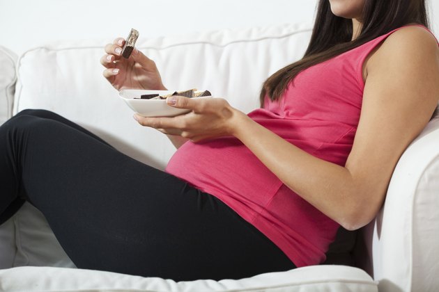 Pregnant woman eating chocolate