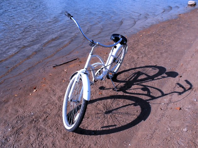 white retro bike on a sand beach