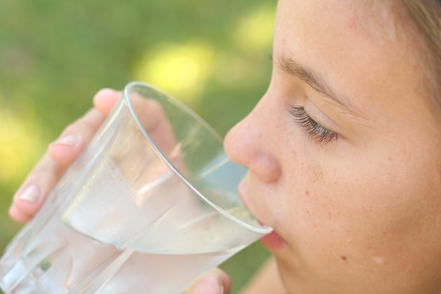 girl drinking a glass of water