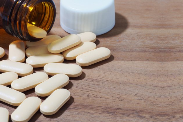 vitamins pills on wooden background
