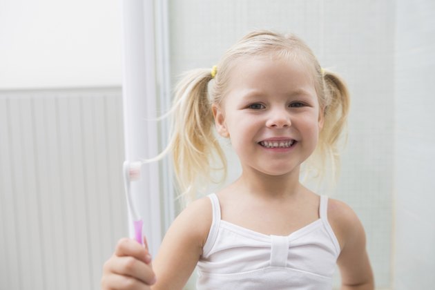 Cute girl brushing her teeth