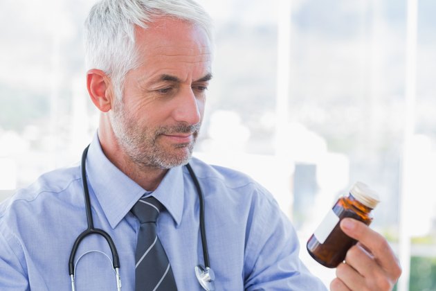 Doctor looking at medicine jar