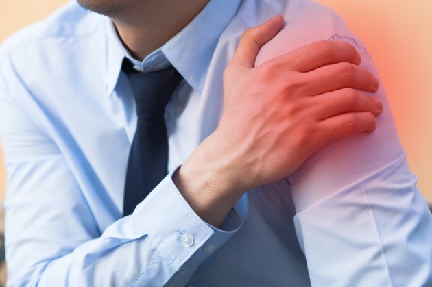 Man having shoulder pain problem with red spot
