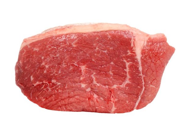 closeup outside round steak on white