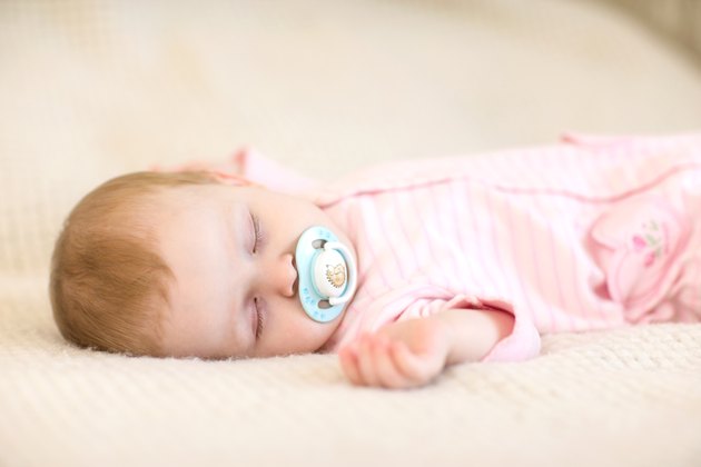 Baby girl sleeping on the bed