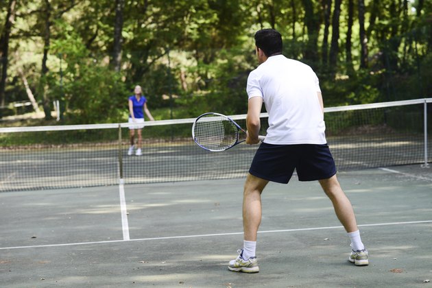 young couple playing tennis outdoor summer