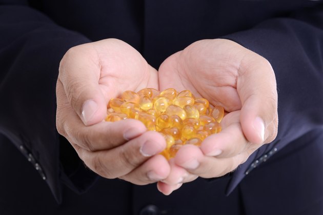 Omega 3 fish oil Evening Primrose capsule on businessman hand