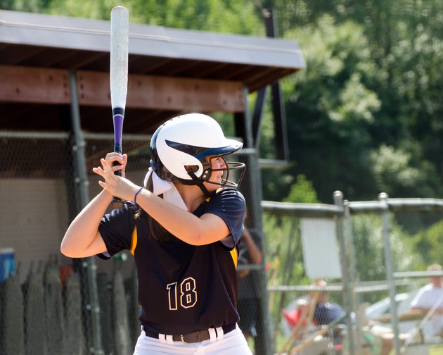 Teen girl playing softball in organized game