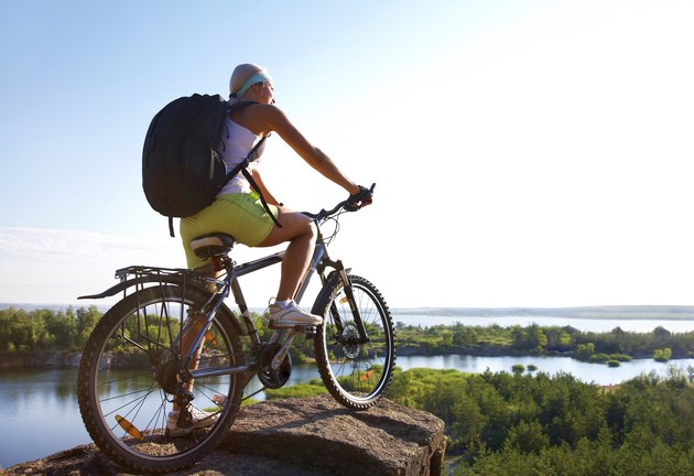 Girl with bicycle on mountain