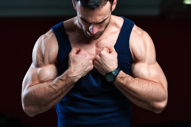 Bodybuilder pulling his shirt