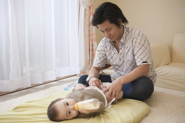 Father Diapering Baby Girl