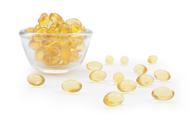 Omega 3 fish oil capsules and glass.