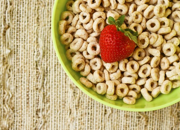 Bowl of cheerios with a strawberry
