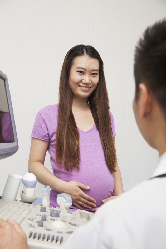 Pregnant Woman Talking With Doctor