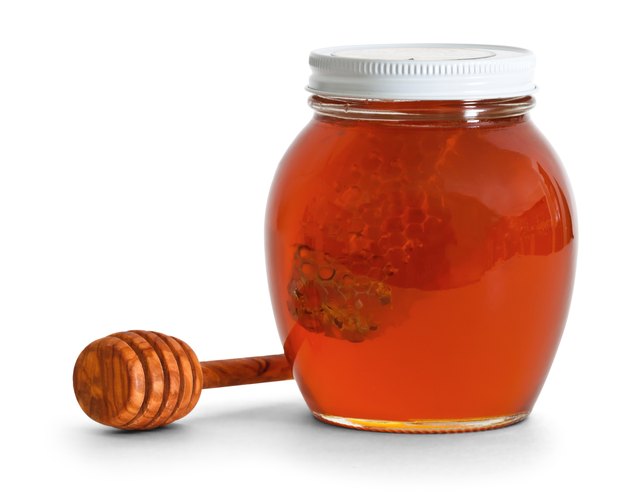 jar of honey with dipper
