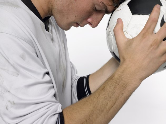 Boy leaning on football