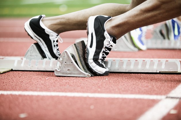 Feet of runners on starting blocks