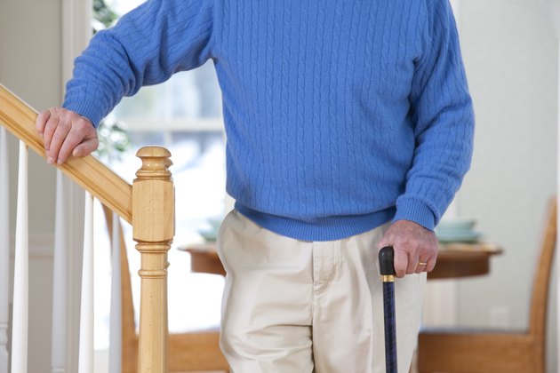 Man suffering from Parkinson's disease and multiple sclerosis standing near steps