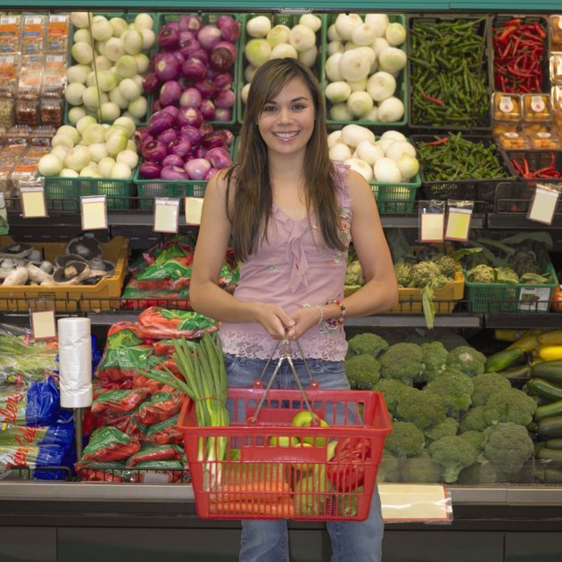 Young woman in produce section of supermarket