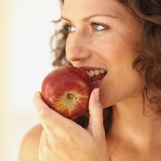 Close-up of a woman eating an apple