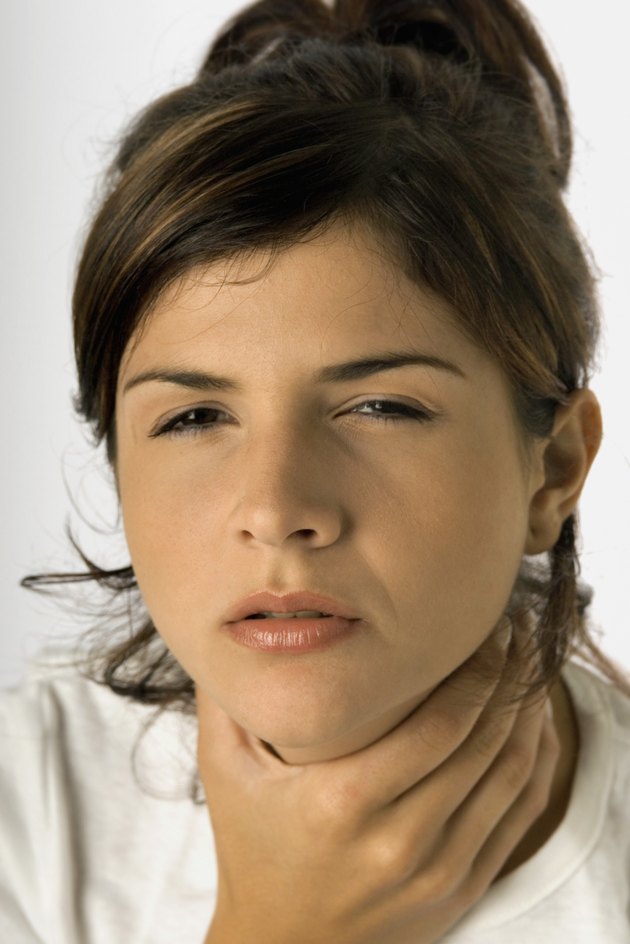 Woman with sore throat and hand on throat, close-up