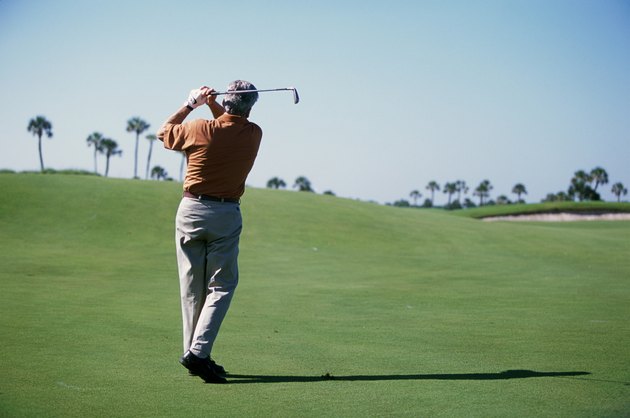 Rear view of a man playing golf