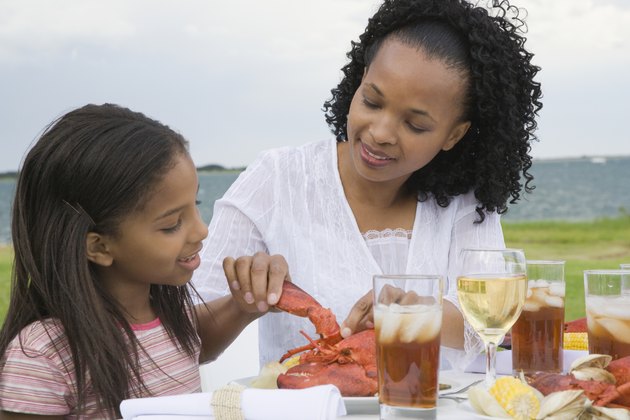 Side profile of a girl and her mother having breakfast