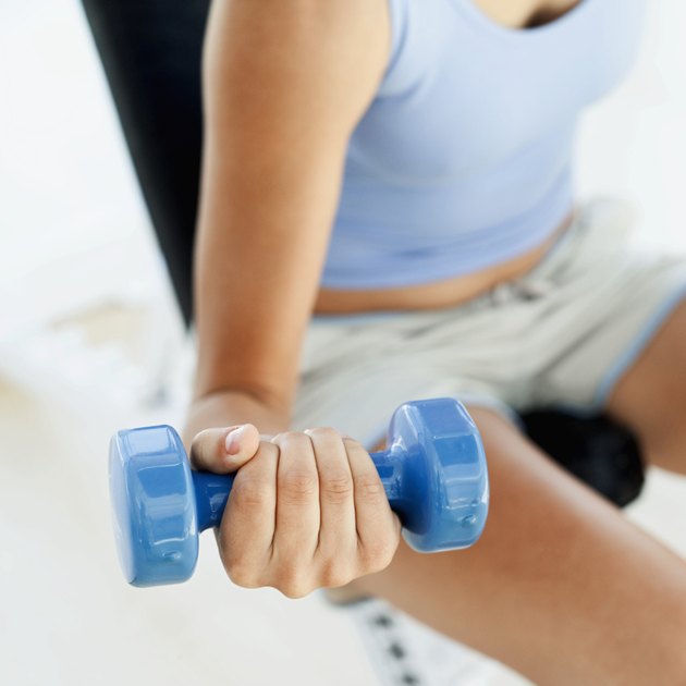 close-up of the hand of a woman holding a dumbbell